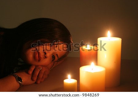 Cute woman with candles in a romantic tone