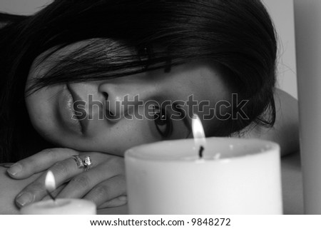 Asian woman with candle in blue