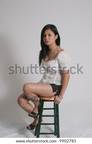 Sexy asian woman sitting on a stool