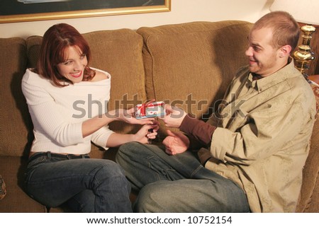 A man giving a gift to a  woman