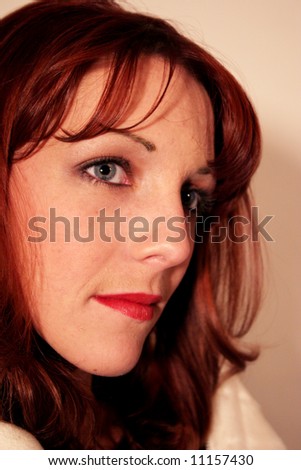 Redhead woman looking right and thinking