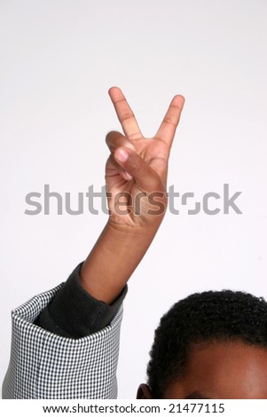 Little boy holds up two fingers for victory or for the number two