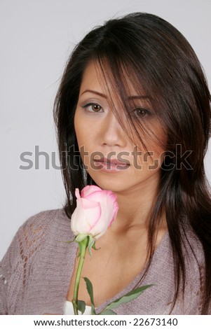 Pretty asian american woman with a pink and white rose