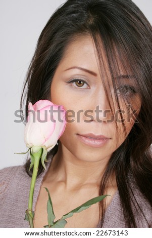 Pretty asian american woman with a pink and white rose