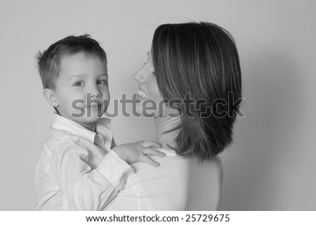 Black and white of mother holding a happy son