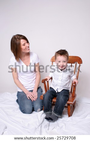 Mother sitting with son who rocks in his rocking chair