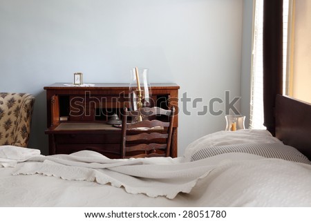 bed with writing table in background