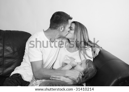 black and white photos of children kissing. stock photo : Black and white, father and mother kissing
