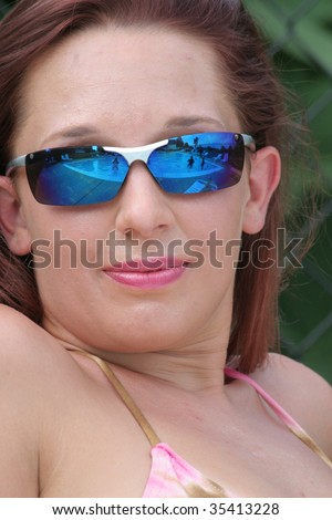 Attractive lady in sunglasses and swim-suit