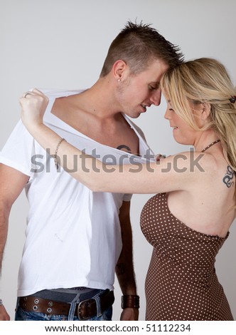 Woman tearing her lover's shirt off