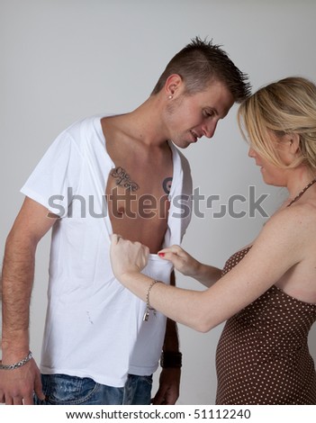 Woman tearing her lover\'s shirt off