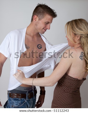 Woman tearing her lover\'s shirt off