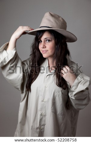 Cute girl in man\'s shirt and hat tipping her hat