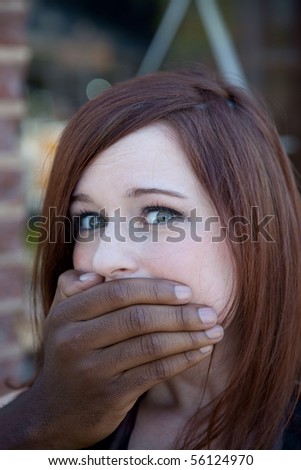 woman with her mouth covered by a man\'s hand