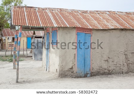 Mud house with blue door in Haiti