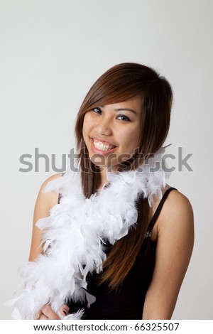 http://image.shutterstock.com/display_pic_with_logo/87914/87914,1291163761,5/stock-photo-pretty-asian-woman-smiling-with-a-feather-boa-66325507.jpg