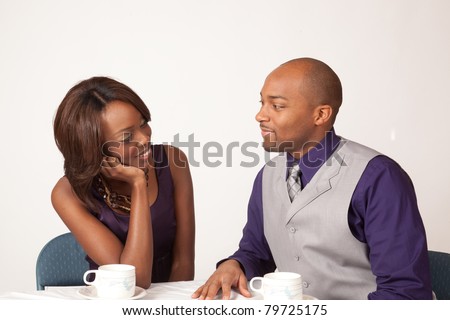 Black coulple sharing a romantic, cup of coffee together
