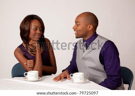 Black couple sharing a romantic, cup of coffee together