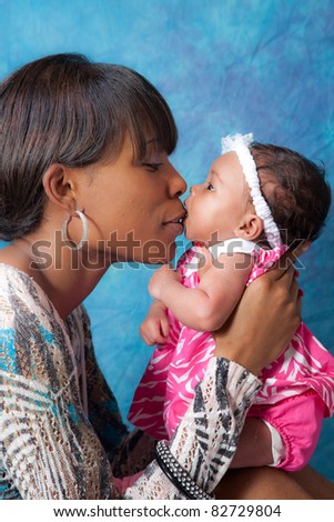 Pretty black mother holding her baby girl