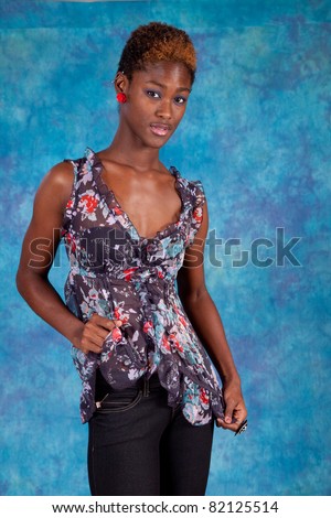 Happy black woman smiling with joy and pulling her blouse