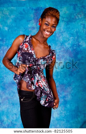 Happy black woman smiling with joy and showing off her abdomen