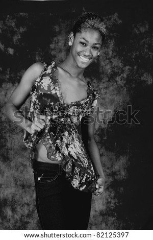 Happy black woman smiling with joy and showing off her abdomen in black and white