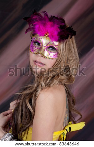 Lovely smiling woman dressed for a costume party, with  mask and hat, and  beads