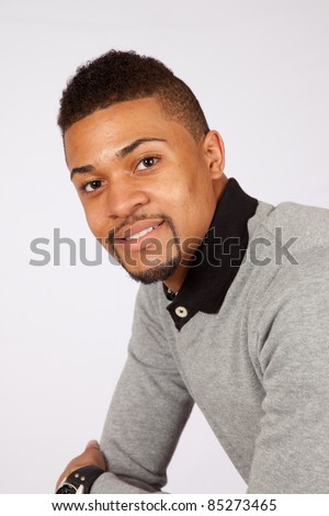 Smiling, happy black man with eye contact, and a friendly expression