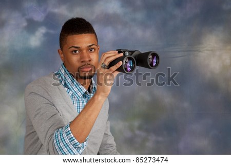 Handsome black man with eye contact, and binoculars
