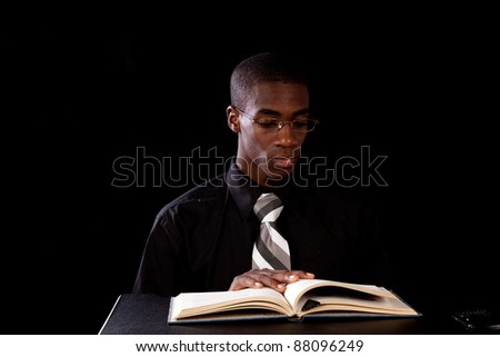 Handsome black man studying and reading a paper for work