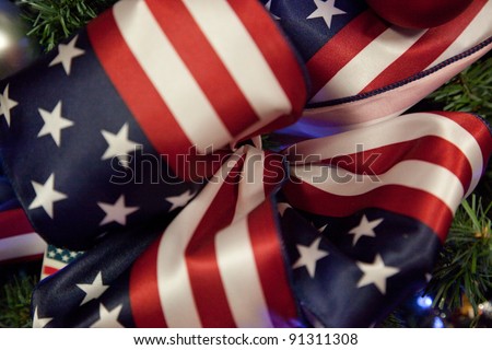 Ribbon of red stripes and white stars on a field of blue, tied in a bow, like a U.S. Flag