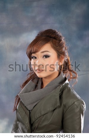 Pretty Asian woman looking at the camera with a friendly but serious expression