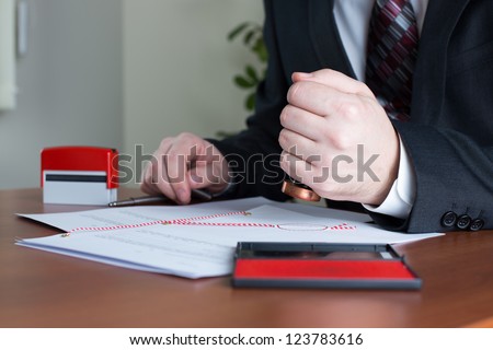 Notary Public stamping a certified copy in his office