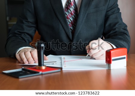 Notary Public in his office signing a contract