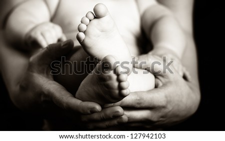 Parents holding their son - black and white photography