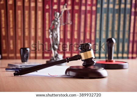 Court Judge\'s gavel, Themis - the goddess of justice, notary public stamper and law codes in the background. Law office. Law concept.