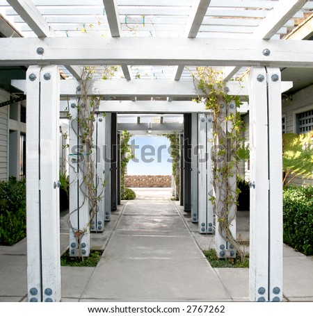 stock photo White Wooden Arbor Pergola with blue sky in distance