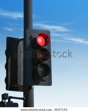 Red Stop Light / Traffic Signal against blue sky