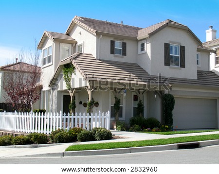 stock photo beautiful large home with white picket fence blue sky