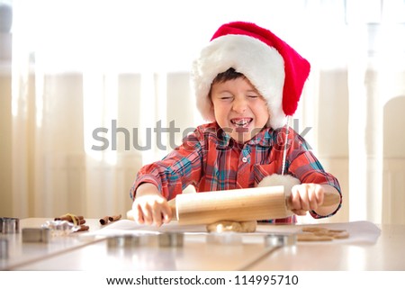Little boy with rolling pins baking and having fun