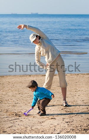 Mother and son enjoying time at the beach
