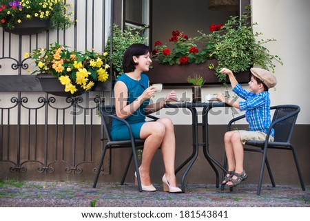 Young mom having coffee with her son
