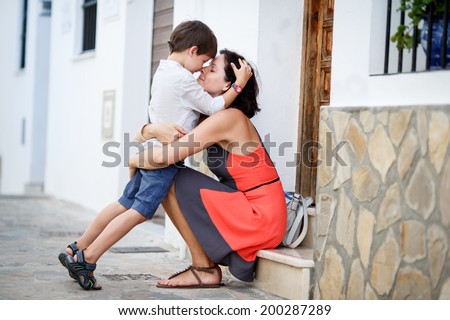 Loving mother and son hugging outdoors on beautiful summer day