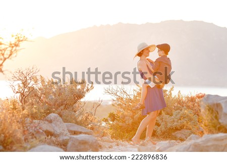 Loving mother and son hugging outdoors on sunset during their summer vacation