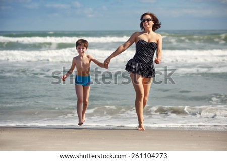 Mother and son having fun on a tropical beach