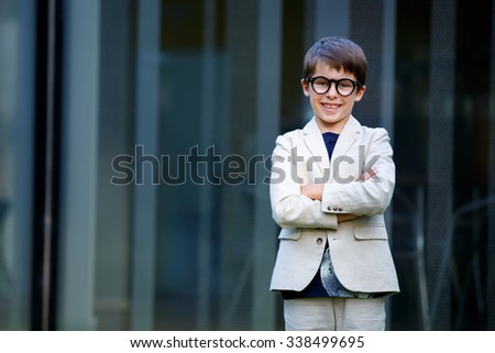 Little boy in a nice suit and glasses. Back to school. Children portrait. Stylish kid in suit