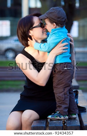 Loving mother and son hugging outdoors