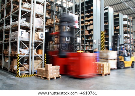 Busy warehouse with pallet trucks working