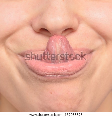 close up of woman tongue licking her nose