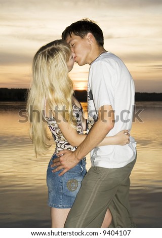 Couple in love, enjoying in nature at the sunset (sunrise)